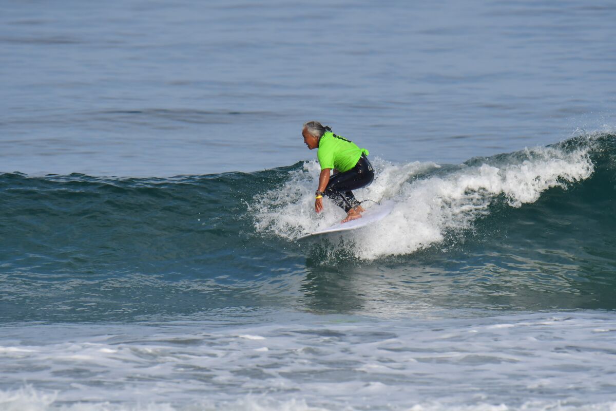 Surfer Guy Takayama rides a small wave