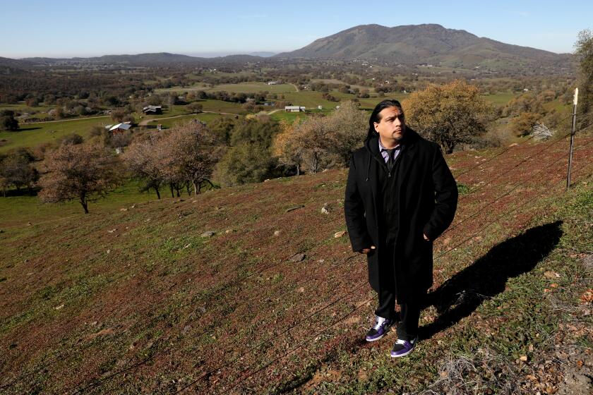 SQUAW VALLEY, CA - JANUARY 11: Roman C. Rain Tree, 40, of Fresno, founder of Rename S-Valley Coalition, an Indigenous group, is a member of the Dunlap Band of Mono Indians and Choi Numni people, overlooking Squaw Valley on Tuesday, Jan. 11, 2022 in Squaw Valley, CA. Rename S-Valley Coalition, an Indigenous group, takes fight to rename town of Squaw Valley, a town of about 3,600 people, to the Board on Geographic Names, a federal body tasked with naming geographic places. The coalition's founder, Roman C. Rain Tree, 40, of Fresno, said Fresno County leaders have ignored his proposal. (Gary Coronado / Los Angeles Times)