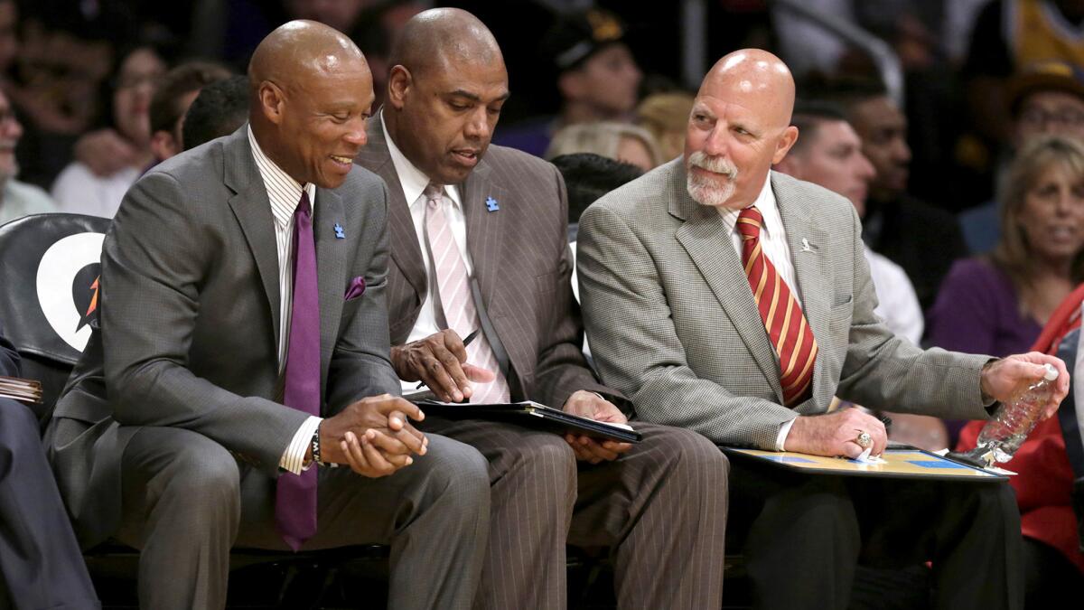 Lakers Coach Byron Scott chuckles with assistant coach Paul Pressey and trainer Gary Vitti during the game against the Clippers on Wednesday.