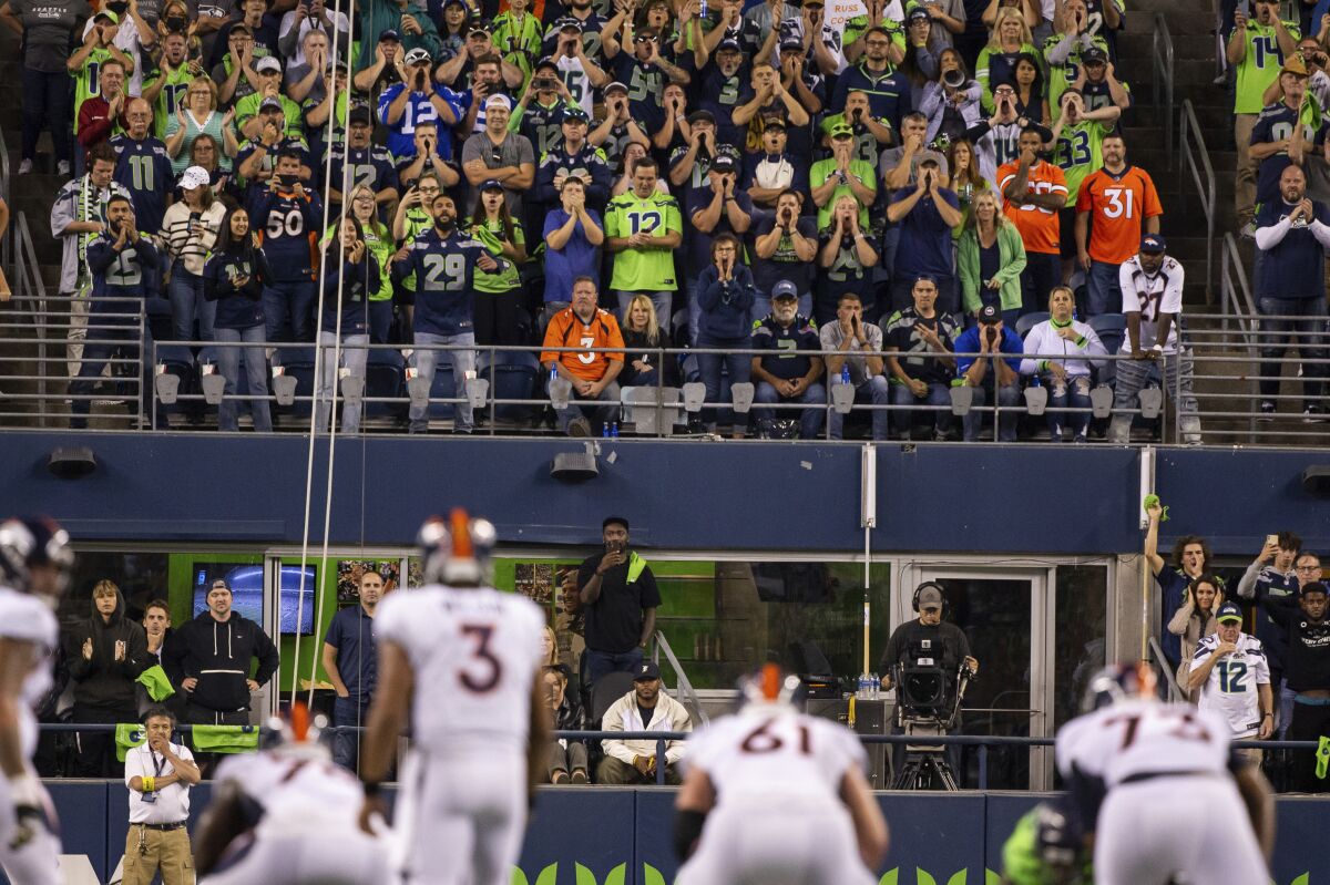 Seattle Seahawks fans yell at Denver Broncos quarterback Russell Wilson (3), their former quarterback, on his return Monday.