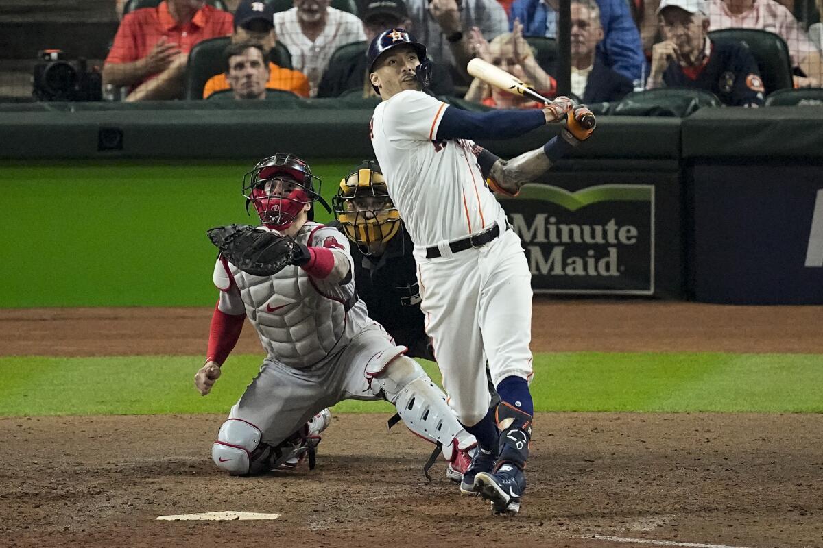 The Astros' Carlos Correa hits a seventh-inning home run against the Red Sox during Game 1 of the ALCS on Oct. 15, 2021.