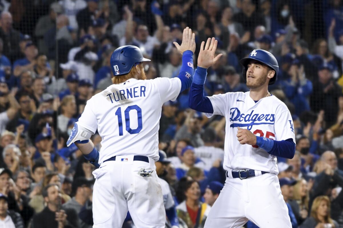 Dodgers' Justin Turner and Cody Bellinger celebrate a play against the Atlanta Braves.