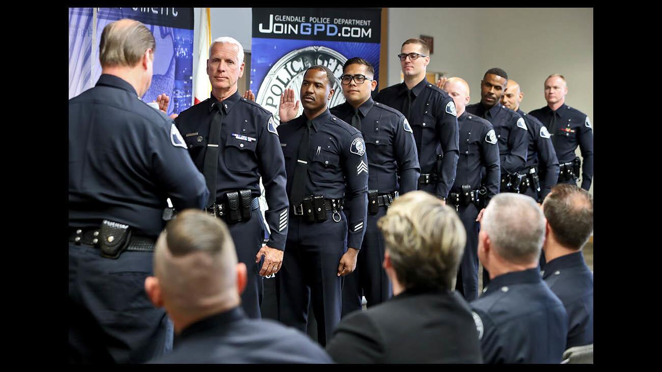 Glendale Police Chief Carl Povilaitis, left, swears in officers during ceremony at the department headquarters in Glendale on Thursday, July 19, 2018.