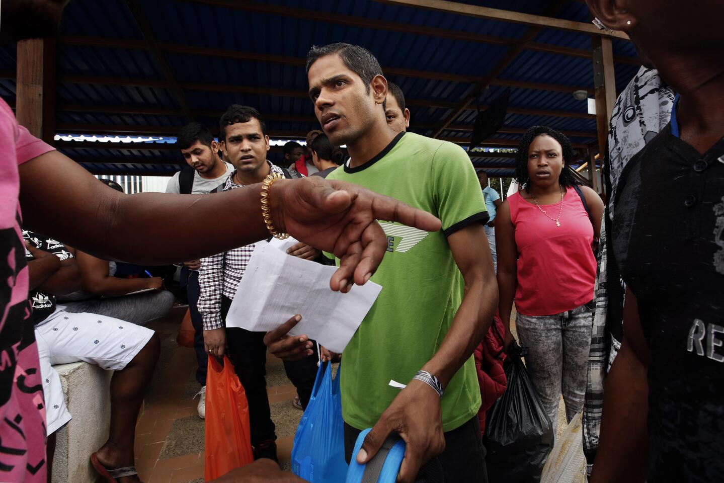 Men from Nepal and India board boats in Turbo, Colombia, headed north. Every day hundreds of migrants from Cuba, Haiti, Nepal, and Africa are attempting to cross the border from Colombia to Panama in the hopes of making it the United States