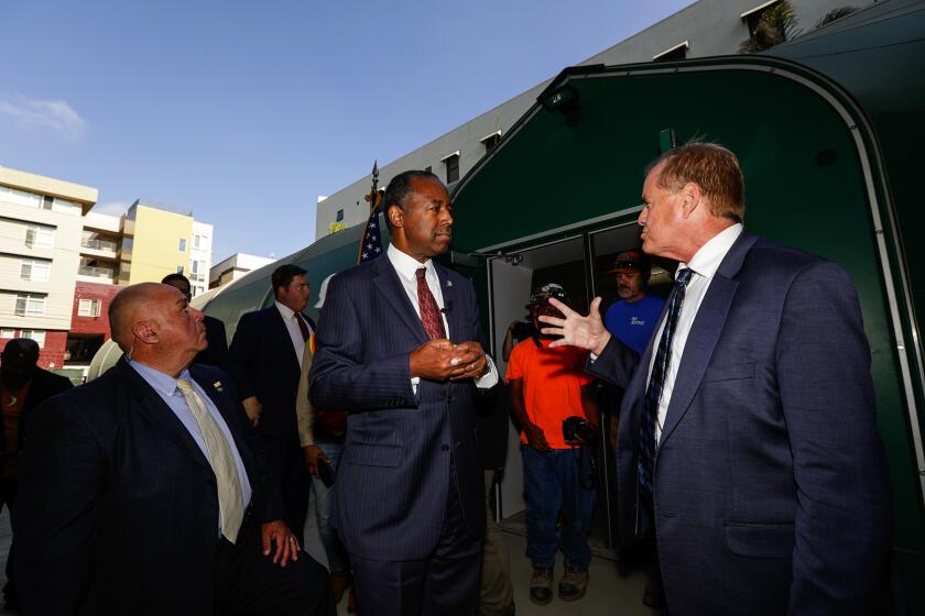Irfan Khan  Los Angeles Times HUD SECRETARY Ben Carson, center, talks to Andy Bales, CEO of Union Rescue Mission, after touring the facility Wednesday. Carson rejected Gov. Gavin Newsom’s request for additional resources for homelessness.