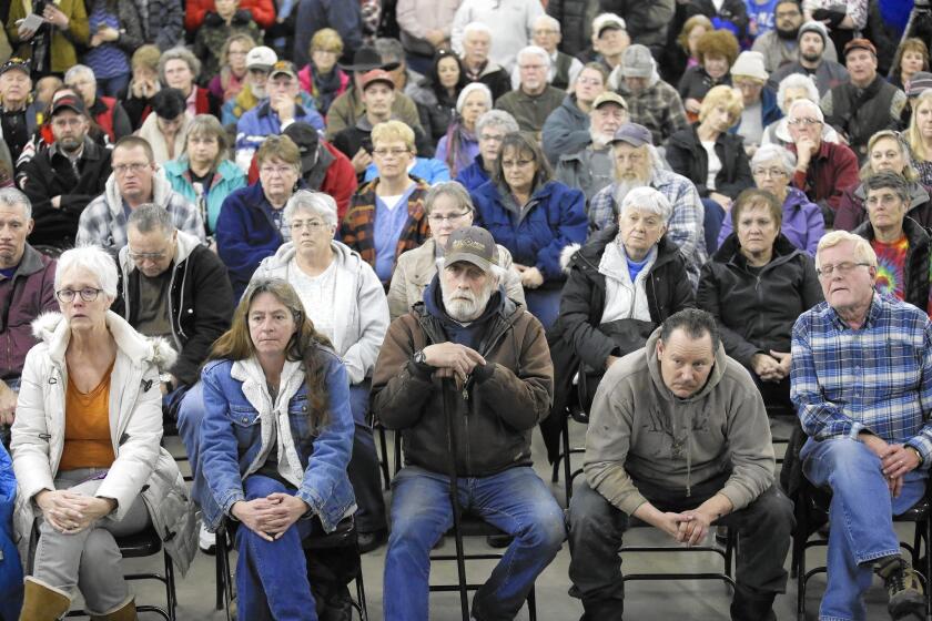 Residents look on as Harney County Sheriff David Ward address concerns at a community meeting in Burns, Ore., on Wednesday night.