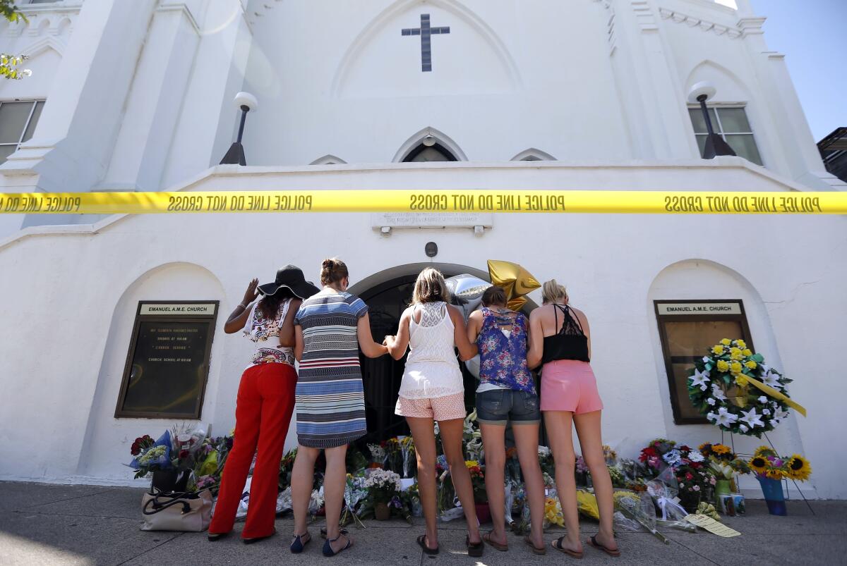 A group prays at a makeshift memorial in front of the Emanuel AME Church in Charleston, S.C., in 2015.  