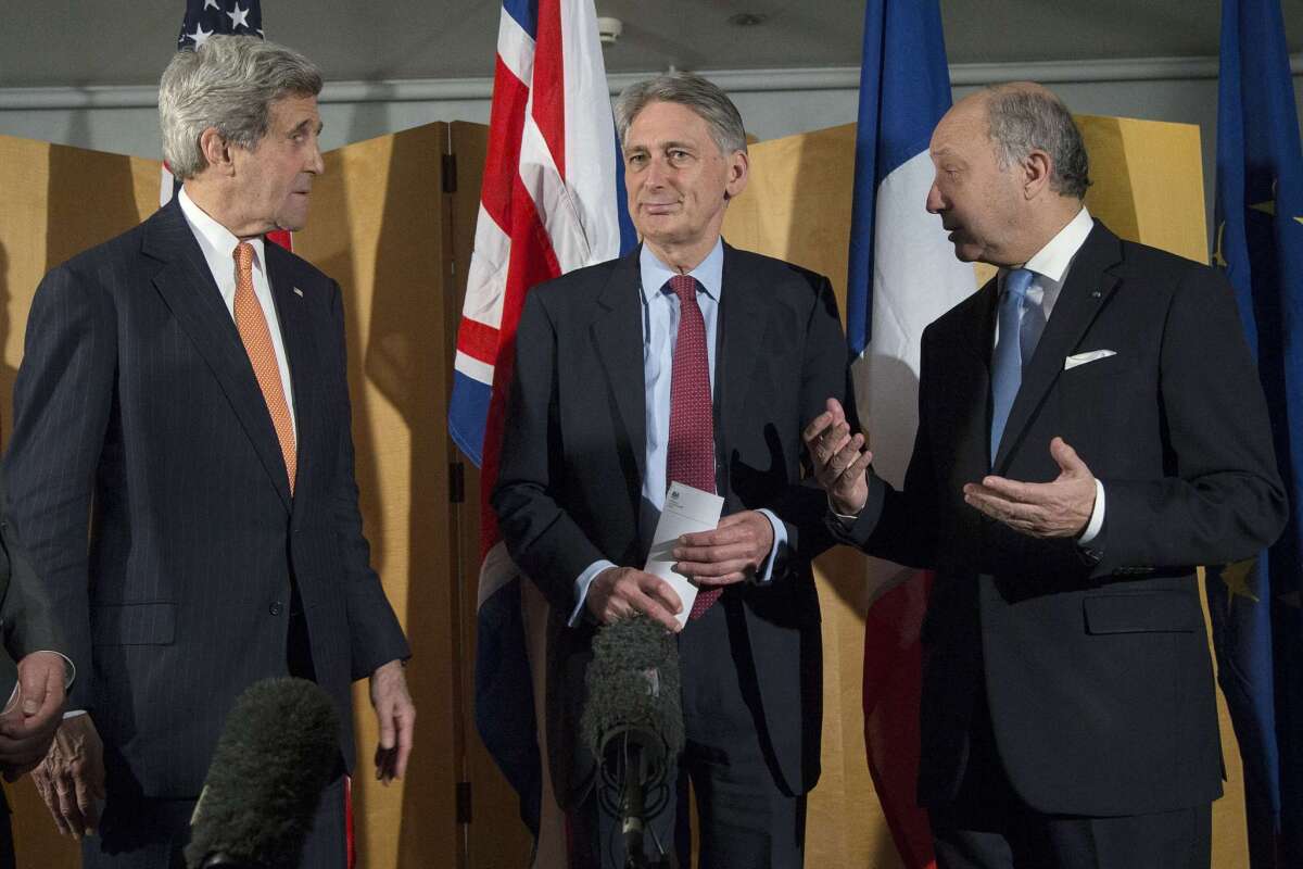 Secretary of State John F. Kerry, left, British Foreign Secretary Philip Hammond and French Foreign Minister Laurent Fabius talk in London earlier this week about negotiations with Iran over its nuclear program.