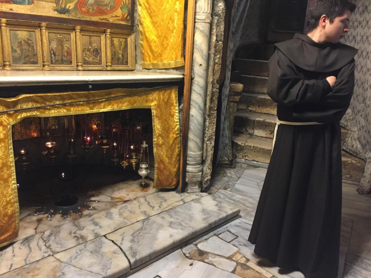 A Franciscan monk stands near the site where Jesus is believed to have been born in the grotto under the Church of the Nativity in Bethlehem.