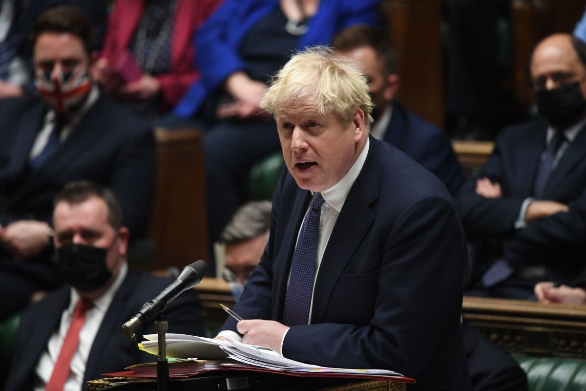 In this handout photo provided by UK Parliament, Britain's Prime Minister Boris Johnson speaks during Prime Minister's Questions in the House of Commons, London, Wednesday, Jan. 5, 2022. (Jessica Taylor/UK Parliament via AP)
