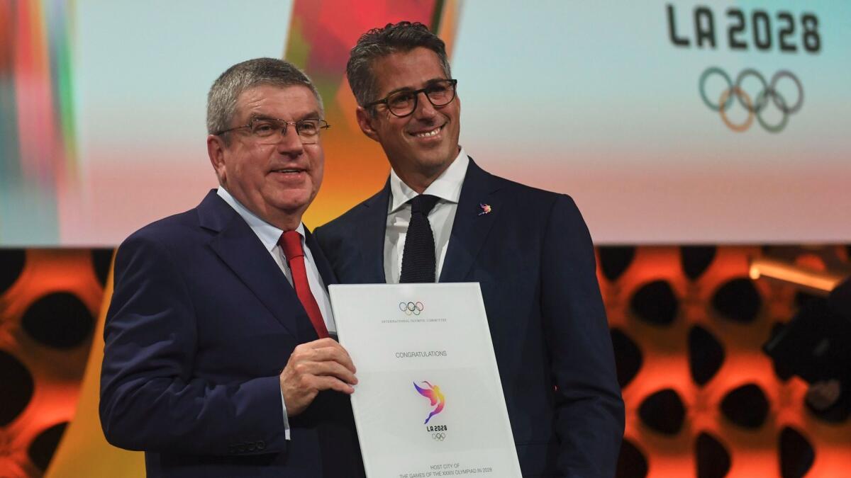 International Olympic Committee President Thomas Bach, left, congratulates LA 2028 Chairman Casey Wasserman after Los Angeles was awarded the 2028 Games on Sept. 13.