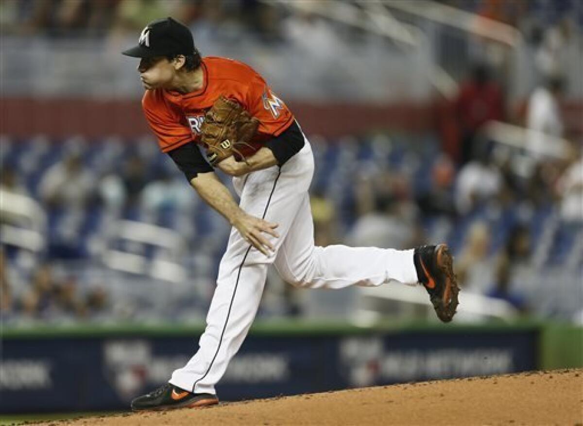 Miami Marlins catcher Jeff Mathis throws to first to put out San