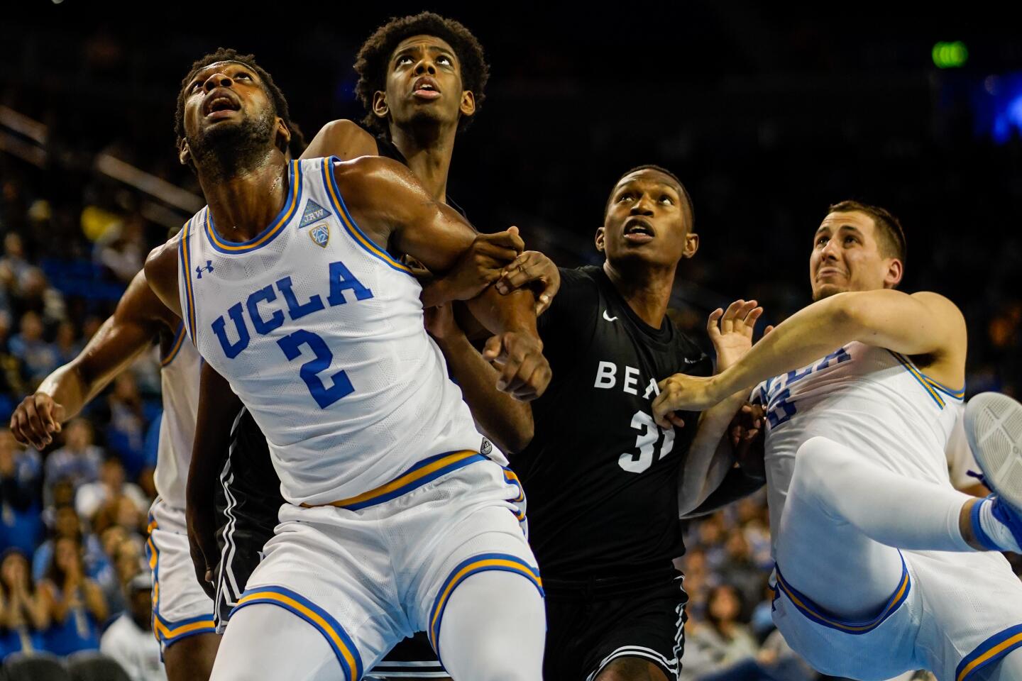 UCLA forward Cody Riley (2) and others watch the ball on a free-throw attempt during the first half of a game Nov. 6 at Pauley Pavilion.