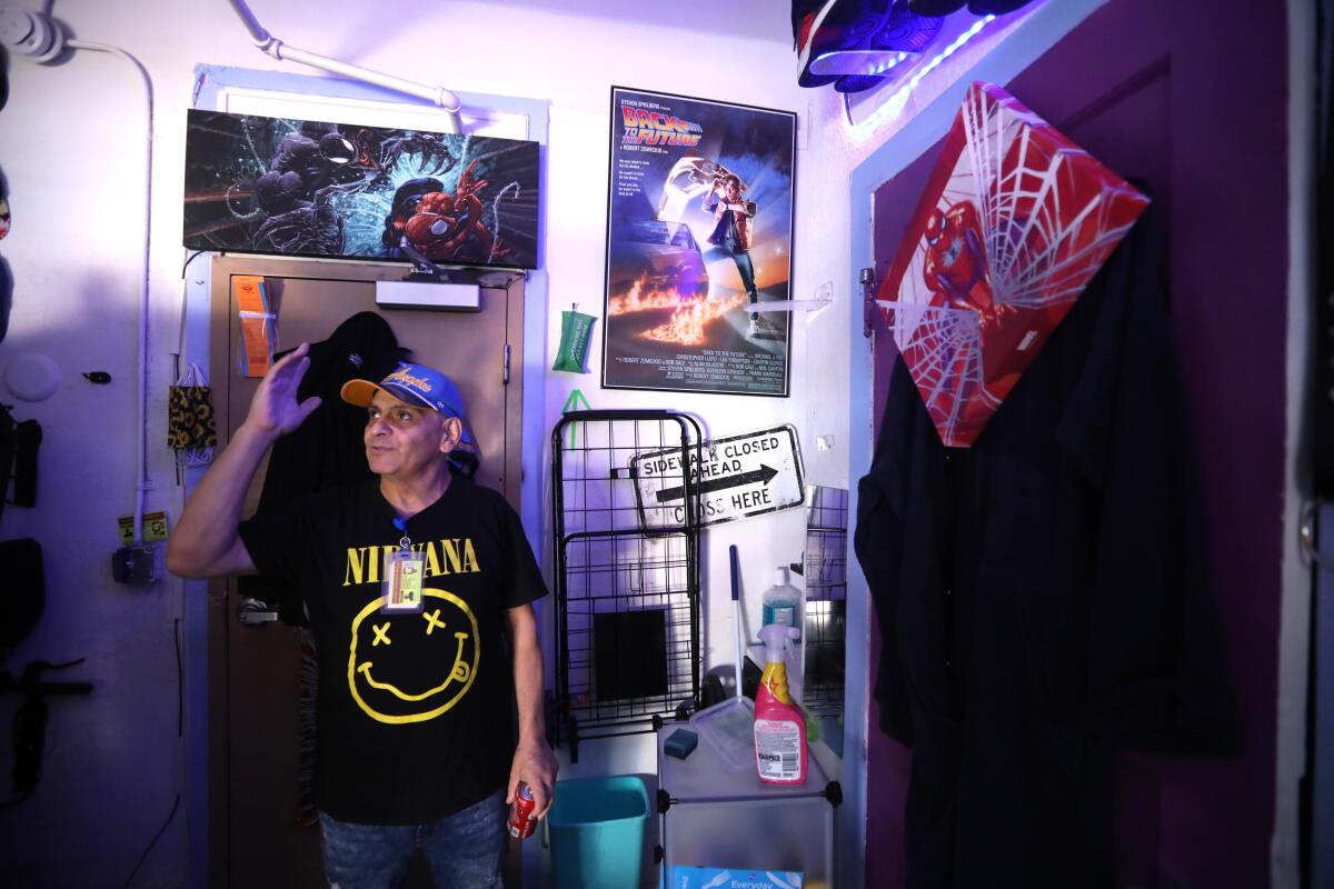 Tenant union leader Nash Stabolito wears a Nirvana shirt as he stands in his room at the Baltimore Hotel in Skid Row