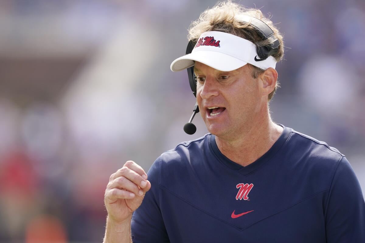 Mississippi coach Lane Kiffin speaks into his headset during the second half Oct. 9, 2021.