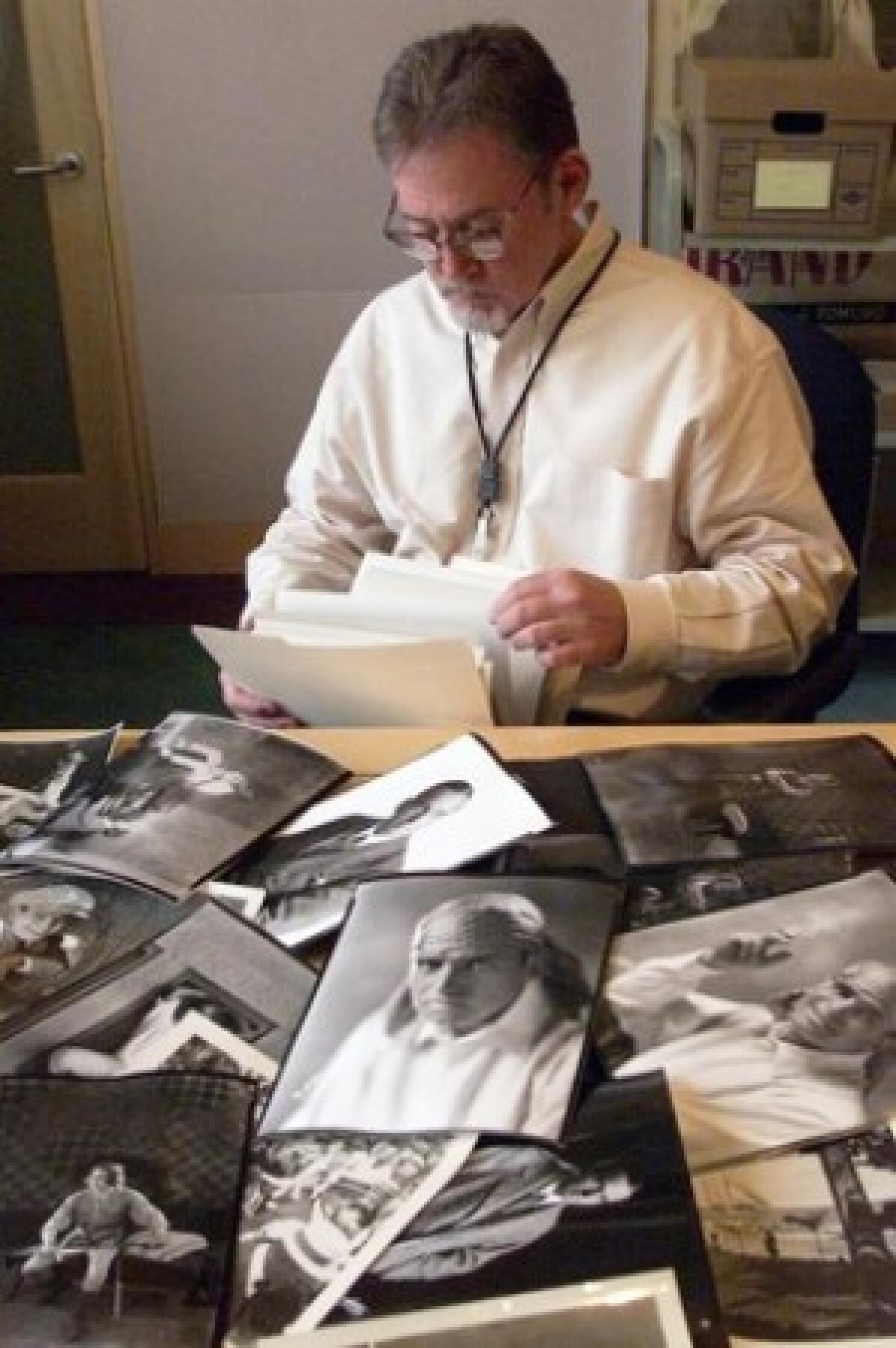 Robert Cushman, photograph curator for the Academy of Motion Picture Arts and Sciences Margaret Herrick Library, goes through pictures of Douglas Fairbanks that were donated by the actor's family.
