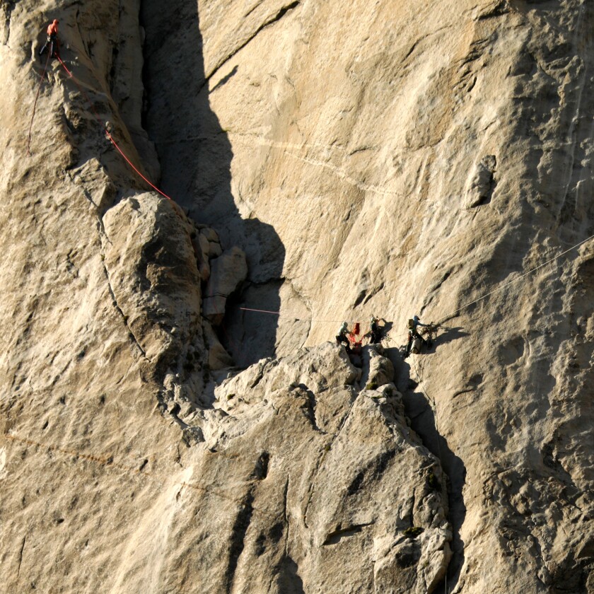 Climbers make their way up a rock face in Yosemite National Park.