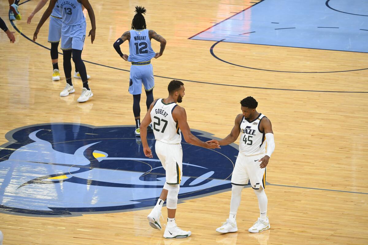 The Jazz's Rudy Gobert (27) and Donovan Mitchell congratulate each other after Utah beat Memphis in Game 3 on May 29, 2021.