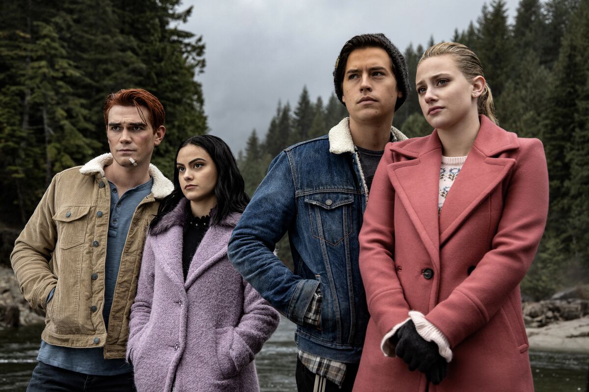 KJ Apa, left, Camila Mendes, Cole Sprouse and Lili Reinhart in a scene from the CW's "Riverdale."