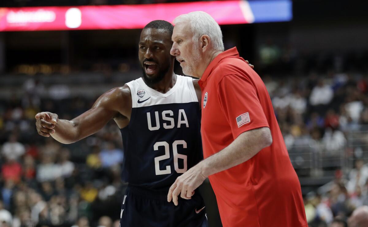 Team USA coach Gregg Popovich talks to guard Kemba Walker during an exhibition game against Spain on Aug. 16, 2019, in Anaheim.