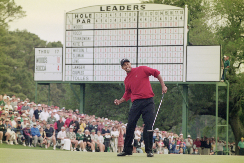 Tiger Woods of the United States celebrates after sinking a 4 feet putt to win the US Masters Golf Tournament.