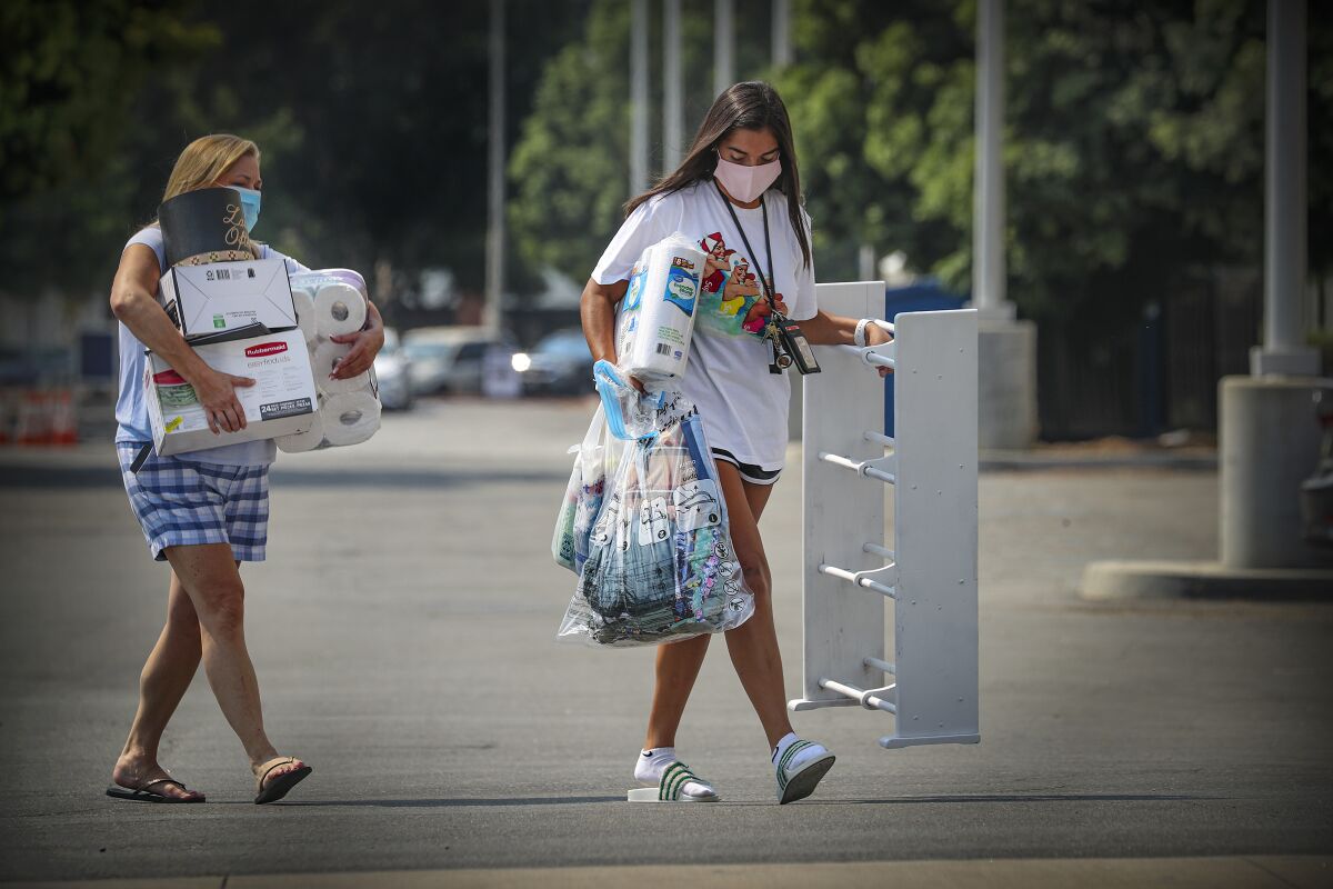 Richelle Meneses helps her 18-year-old daughter Sidney Meneses move into dorms at Cal State University of Fullerton.