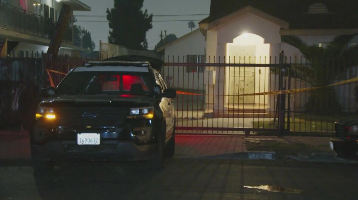 A police cruiser is parked outside a home at night 