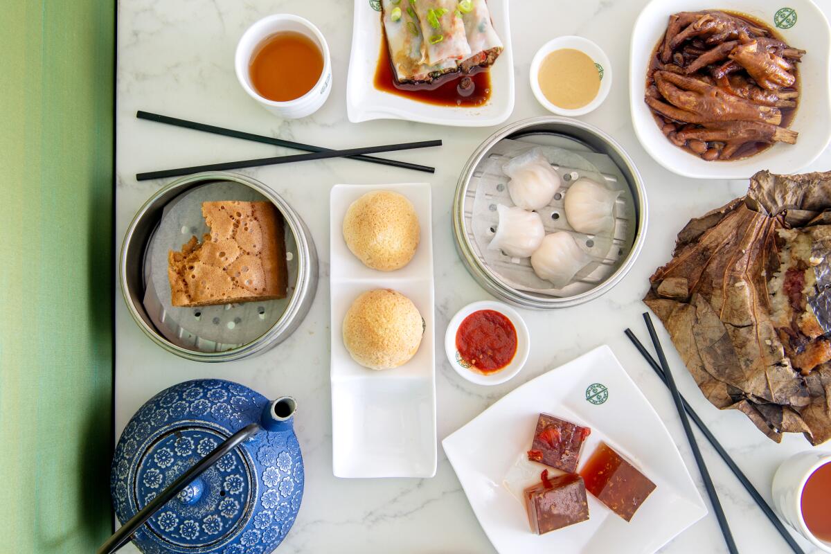 Clockwise from top left, steamed rice roll, chicken feet, rice in lotus leaf, sweet osmanthus with goji berry, pork buns, steamed egg cake and shrimp dumplings (center) from Tim Ho Wan in Irvine.