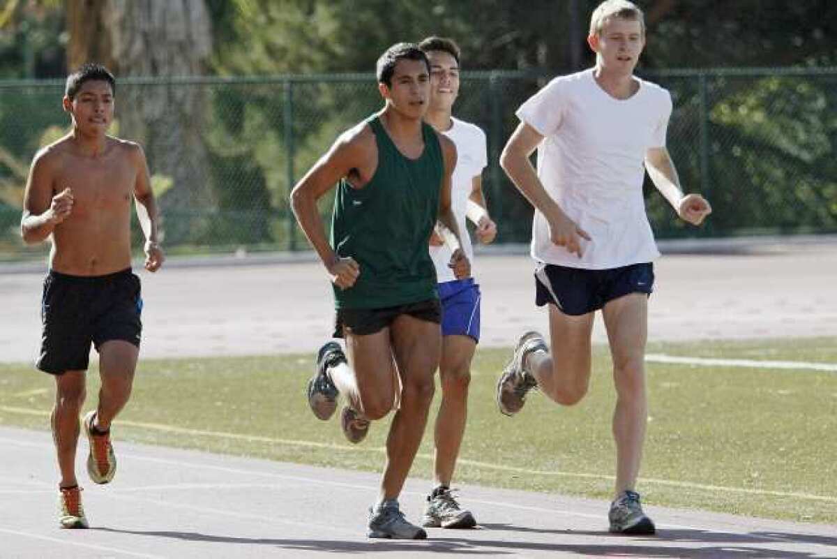 GCC's Issac Diosdado, center, and other runners prepare for the state meet at Glendale Community College.