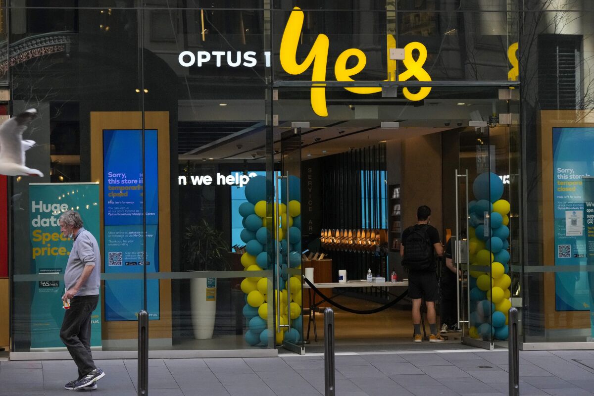 FILE - A customer waits for service at a Optus phone store in Sydney, Australia, Thursday, Oct. 7, 2021. The Australian government said on Monday, Sept. 26, 2022, it was considering tougher cybersecurity rules for telecommunications companies after Optus, the nation’s second-largest wireless carrier, reported personal data of 9.8 million customers had been breached. (AP Photo/Mark Baker, File)