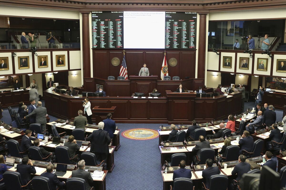 FILE - In this Wednesday, May 19, 2021 file photo, The Florida House voted to pass Seminole gambling compact during a special session in Tallahassee, Fla. The Seminole Tribe will be able to operate sports betting under an agreement with Republican Gov. Ron DeSantis. Federal officials approved a deal Friday, Aug. 6, 2021 that will allow the Seminole Tribe to operate sports betting and add roulette and craps to its seven Florida casinos, with the state potentially receiving $20 billion over the next 30 years.(AP Photo/Steve Cannon, File)