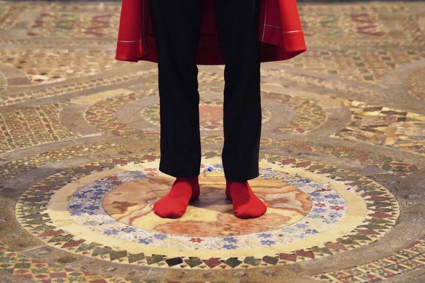 Abbey Marshal Howard Berry stands at the centre of the Cosmati pavement, located before the altar, during a photo call at Westminster Abbey, central London, to announce special events to celebrate the Coronation of King Charles III, Thursday March 23, 2023. Events at the Abbey will include barefoot tours of the Cosmati pavement, one of the UK's greatest medieval art treasures and the place of coronations for over 700 years and where the Coronation Chair will be placed to crown the King. (Jonathan Brady/PA via AP)