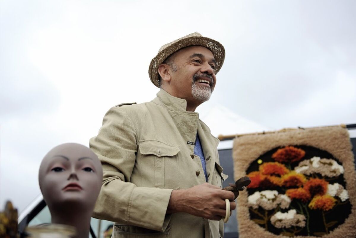 Christian Louboutin likes to wear a shopping uniform, which includes a safari jacket, for his flea market trips.