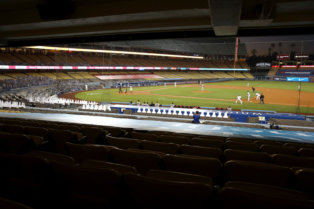 A view of a game being played at Dodger Stadium with cardboard cutouts in some seats.
