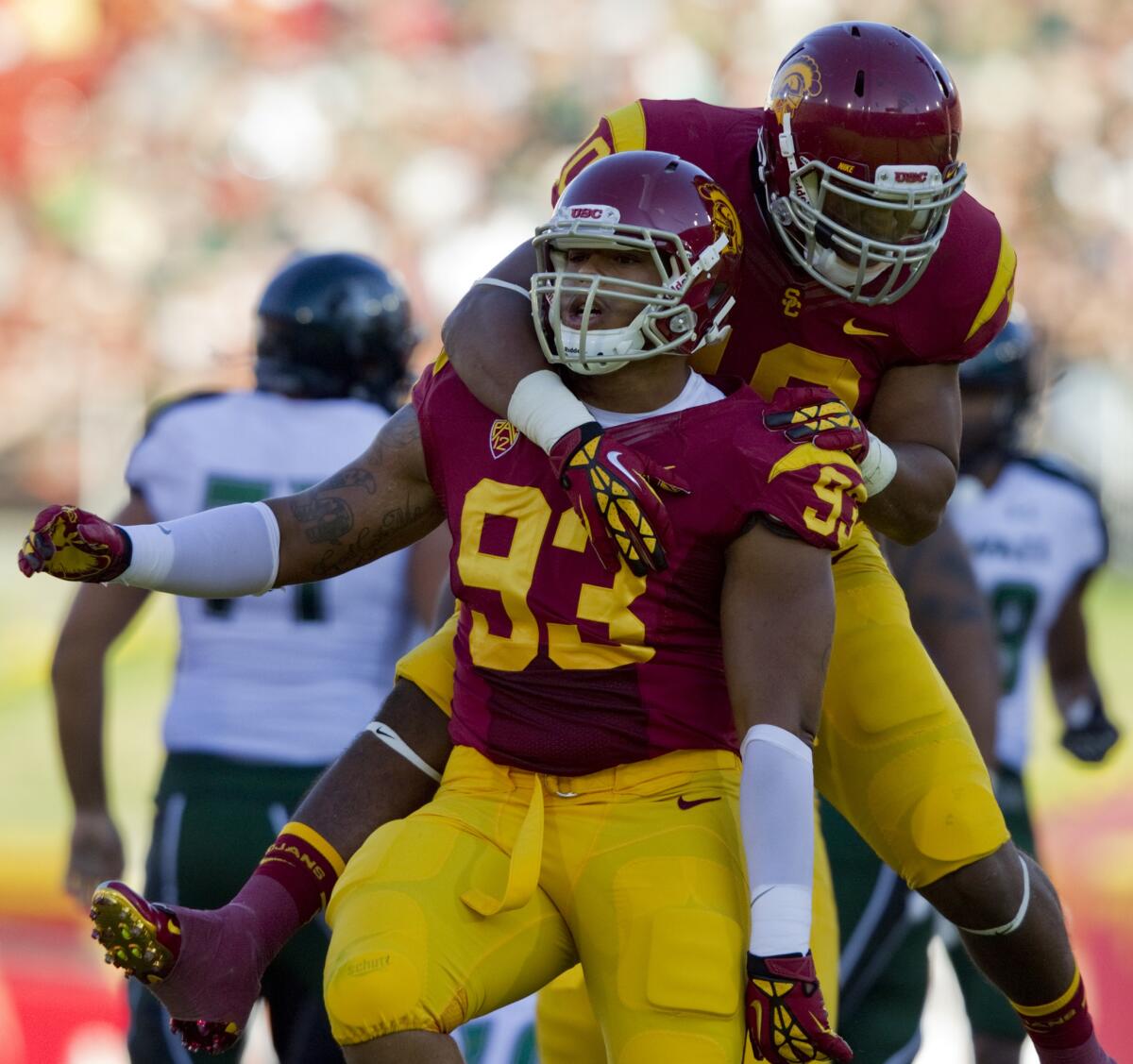 USC defensive end Greg Townsend Jr., bottom, is congratulated by teammate Hayes Pullard after a sack in 2012.