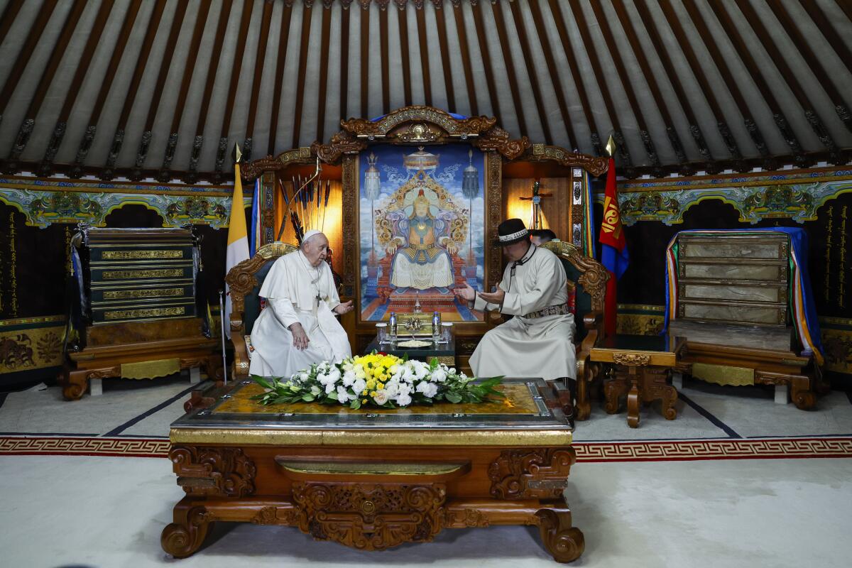 Mongolian President Ukhnaagiin Khurelsukh, right, and Pope Francis meet