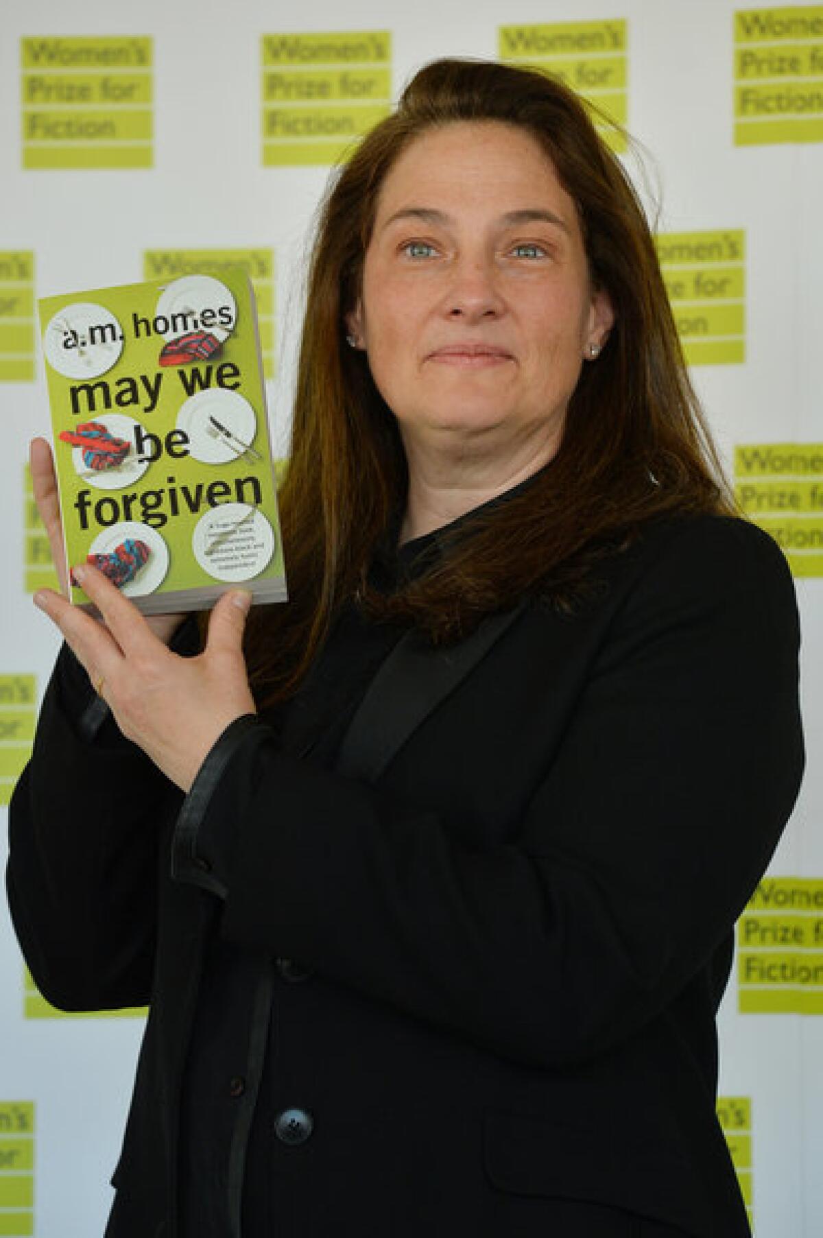 A.M. Homes with her book "May We Be Forgiven," which won the 2013 Women's Prize for Fiction.