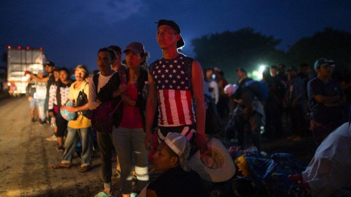 Central American migrants, part of a caravan hoping to reach the U.S. border, wait for a ride in Donaji, Mexico, on Nov. 2.