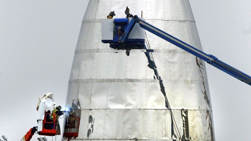 SpaceX continues work on its prototype Starship hopper in Boca Chica, Texas, on Wednesday.