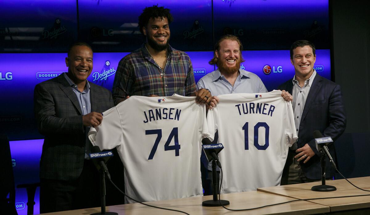 From left, Dodgers Manager Dave Roberts, pitcher Kenley Jansen, third baseman Justin Turner and President of Baseball Operations Andrew Friedman at news conference Wednesday reintroducing the two players.