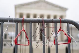 WASHINGTON, DC - MAY 14: Hangers are seen on a barricade as abortion rights activists participate in a Bans Off Our Bodies rally and march to the Supreme Court of the United States on Supreme Court of the United States on Saturday, May 14, 2022 in Washington, DC. Abortion rights supporters are holding rallies across the country urging lawmakers to codify abortion rights into law after a leaked draft from the Supreme Court revealed a potential decision to overturn the precedent set by landmark Roe v. Wade. (Kent Nishimura / Los Angeles Times)