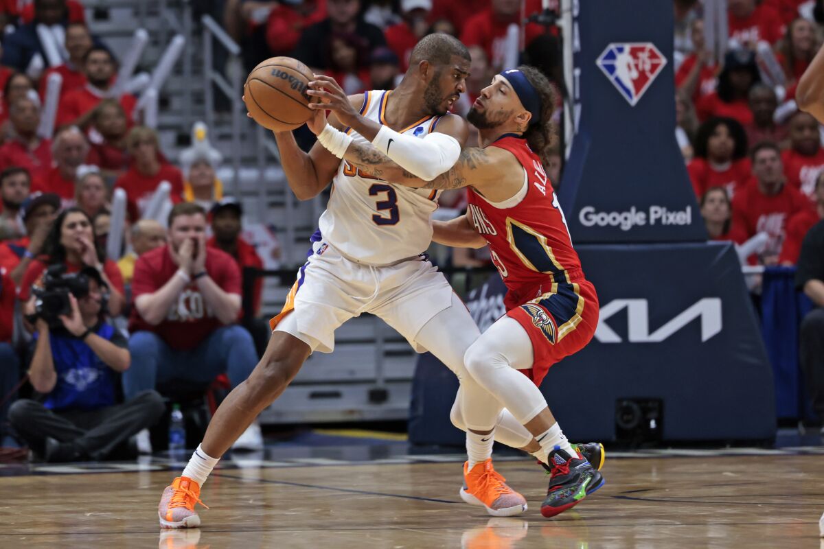 Suns guard Chris Paul is fouled by Pelicans guard Jose Alvarado during the first half of Game 3 on April 22, 2022.