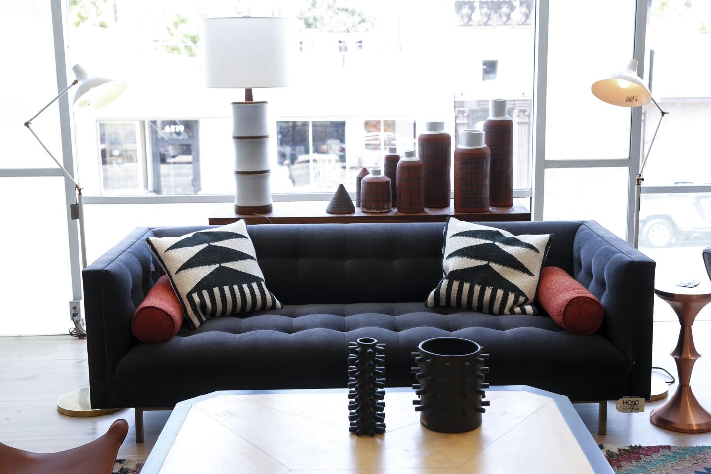 Trousdale tufted sofa by Lawson-Fenning, starts at $2,950. In the background, a ceramic lamp by Martz, $1,250. On the coffee table, ceramic vessels by Los Angeles-based ceramist Ben Medansky. At right, Lawson-Fenning's own spun metal side table, $450.