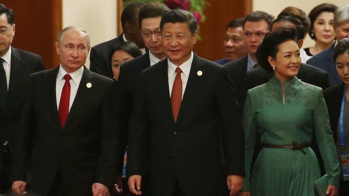 Chinese President Xi Jinping, center, and his wife, Peng Liyuan; Russian President Vladimir Putin, left, and other leaders arrive for a banquet for the Belt and Road Forum at the Great Hall of the People in Beijing on May 14, 2017.