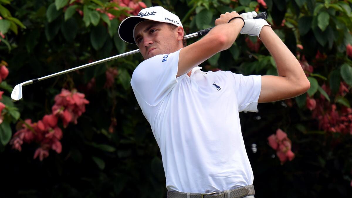 Justin Thomas watches his approach shot at No. 11 duirng the final found of the CIMB Classic on Sunday.