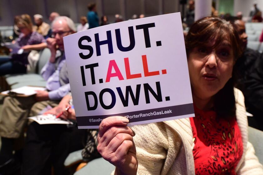 Sheryl Goldfarb, who said she has lived in Porter Ranch for 27 years, holds a placard expressing her feelings at a town hall meeting about the gas leak at Shepard of the Hills Church on Friday.