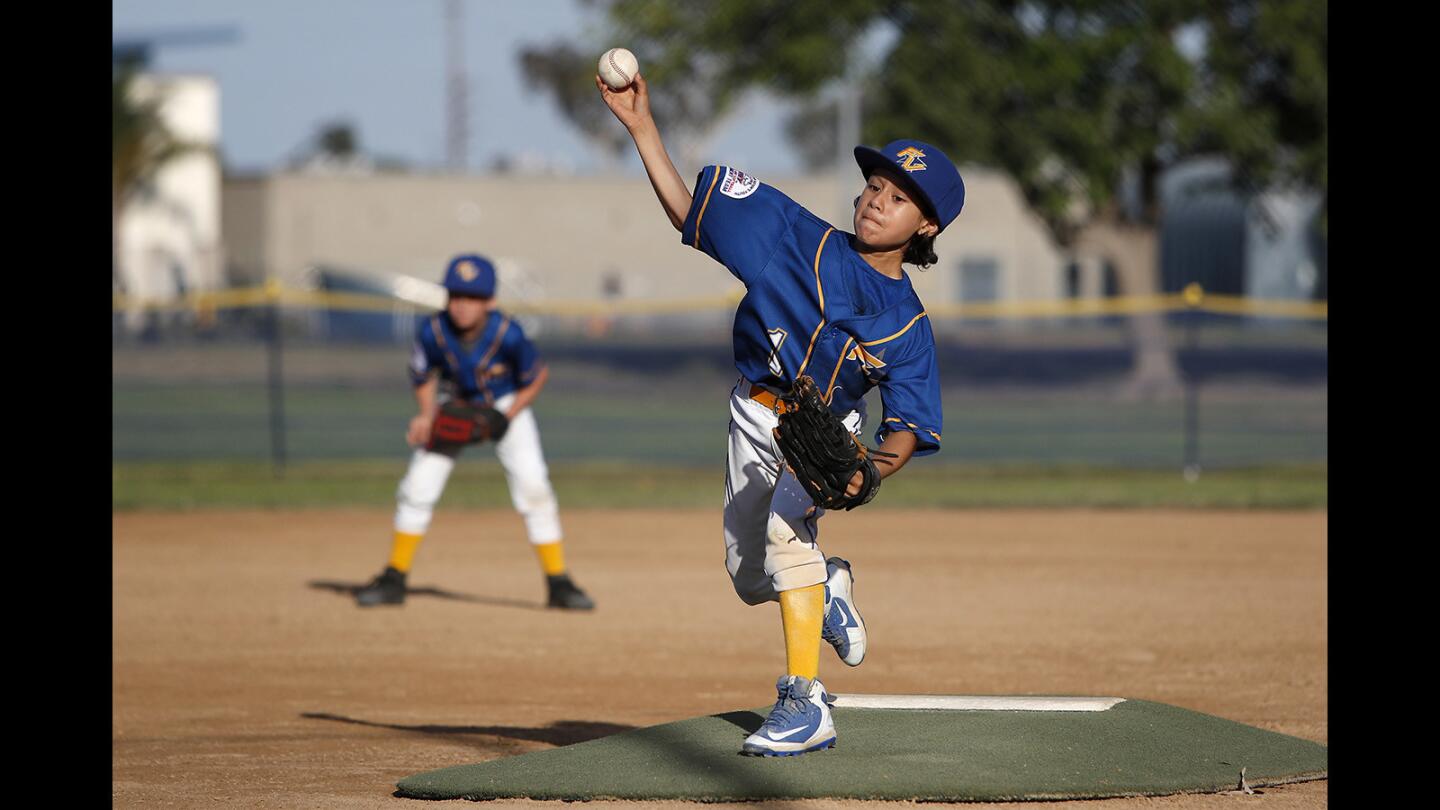 Fountain Valley starter Xavier Banderas pitches against Cypress during the first inning in the PONY Pinto 8-and-under region tournament at Oak Knoll Park in Cypress on Friday, June 29.