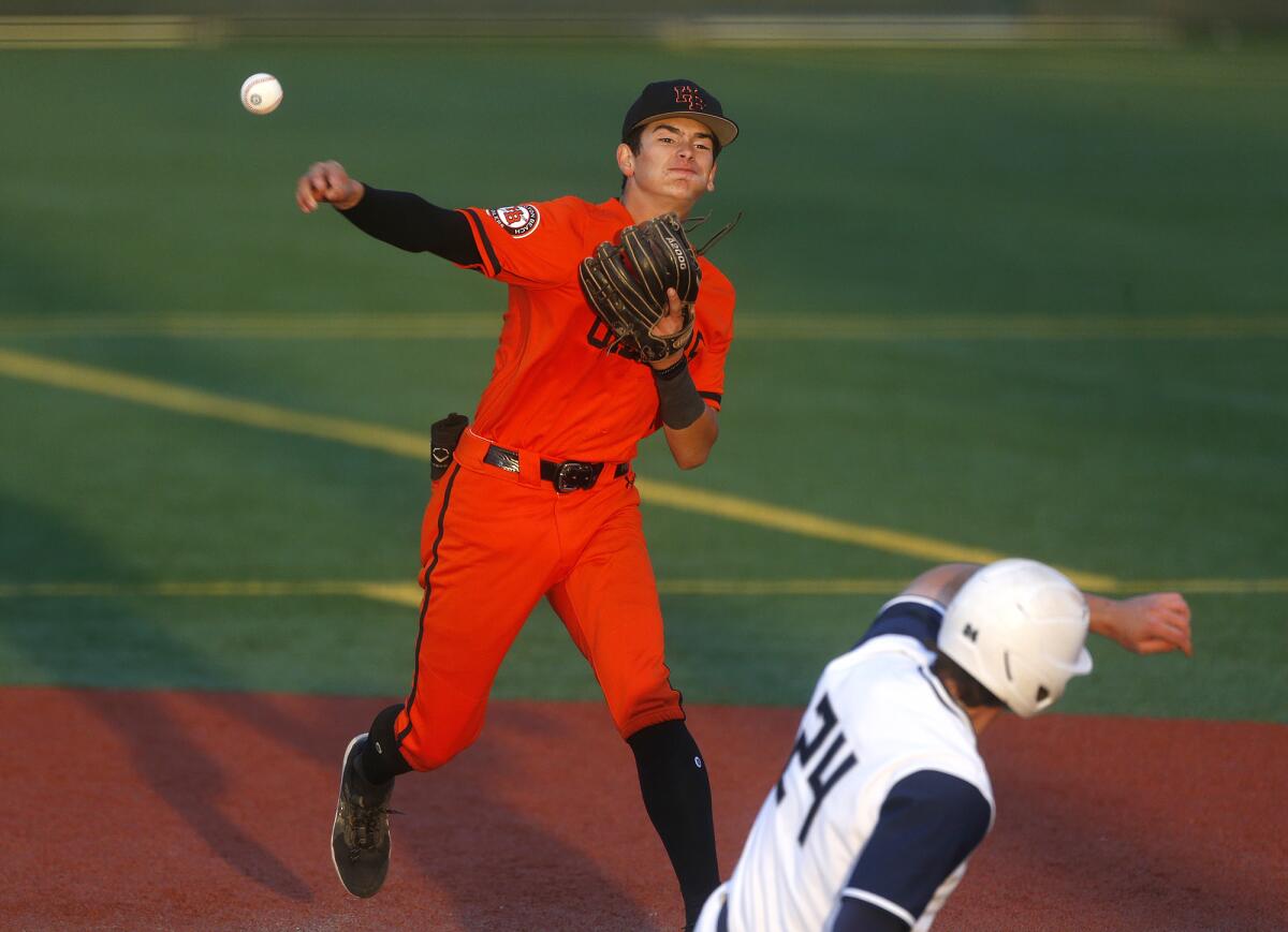 Huntington Beach's CJ Weinstein turns a double play in the semifinals of the Boras Classic against on Thursday.