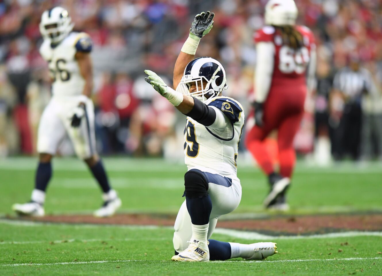 Rams defensive tackle Aaron Donald celebrates his third sack of the game against Arizona Cardinals at State Farm Stadium on Sunday.