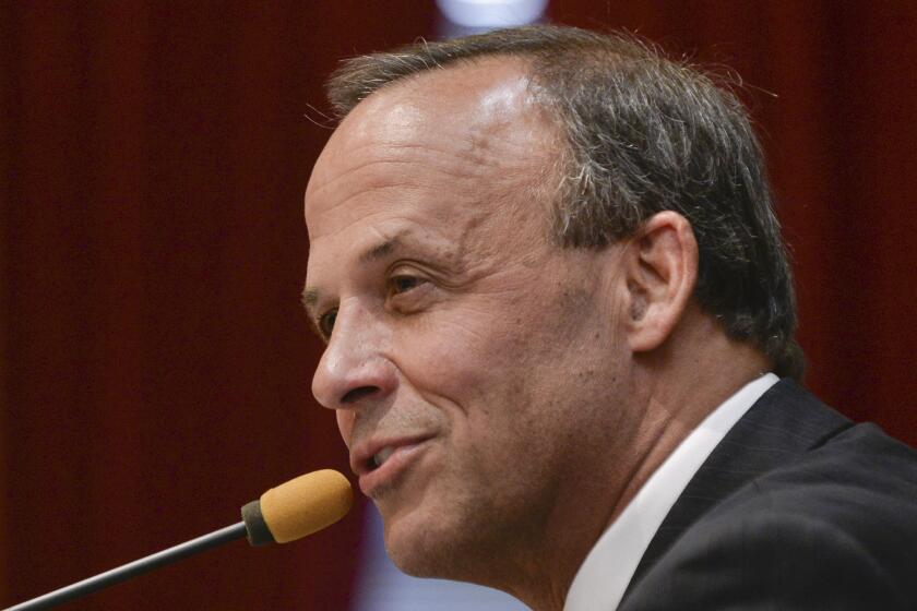 Peoria, Ill. Mayor Jim Ardis addresses a City Council meeting in 2013. Police officers trying to find out who was behind a fake Twitter account set up in the name of Peoria's mayor raided a home Tuesday, seizing computers and phones, and questioning several people.